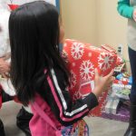 young girl just received a gift at the christmas dinner