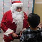 Santa-Claus giving out presents to children
